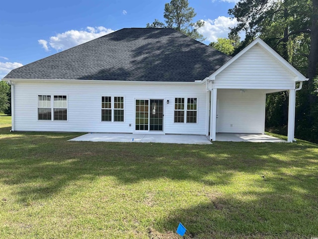 back of house featuring a patio, a lawn, a ceiling fan, and a shingled roof