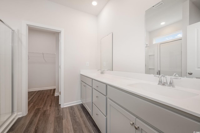 kitchen with light stone counters, a breakfast bar area, a kitchen island with sink, dark hardwood / wood-style floors, and stainless steel appliances