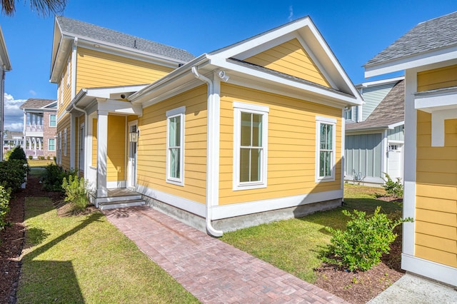 view of property exterior with a lawn