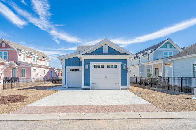 view of front of house featuring decorative driveway, a residential view, fence, and board and batten siding