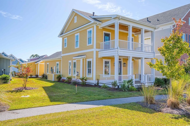 view of front facade featuring covered porch, a balcony, and a front lawn