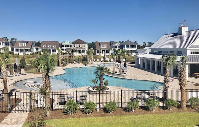 pool featuring a patio area, a residential view, and fence