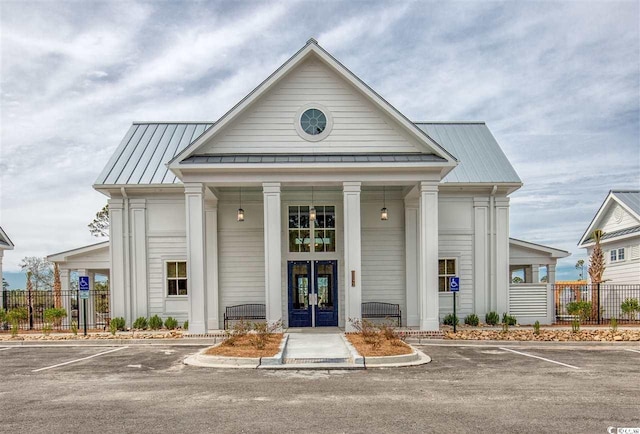 view of property with uncovered parking and fence