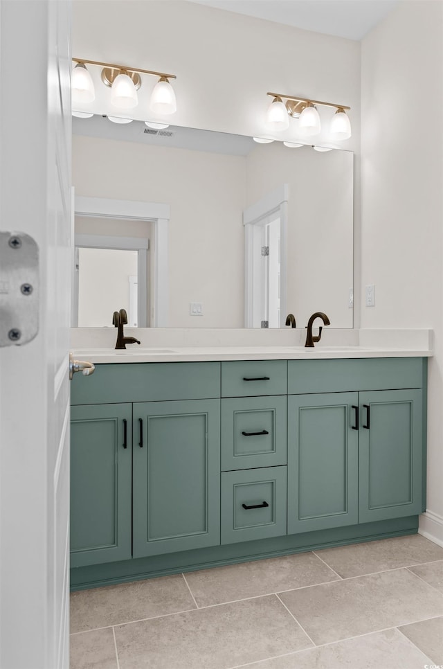 bathroom with tile flooring, large vanity, and dual sinks