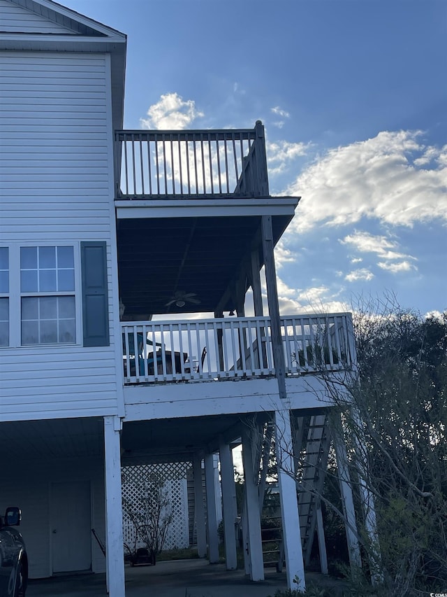 exterior space featuring a carport, stairs, and a ceiling fan