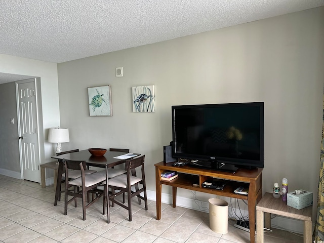 dining room with a textured ceiling and light tile floors