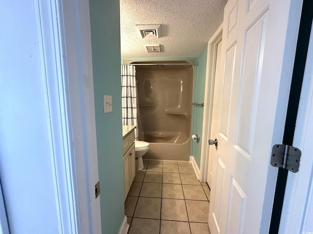 full bathroom with toilet, bathtub / shower combination, tile floors, vanity, and a textured ceiling