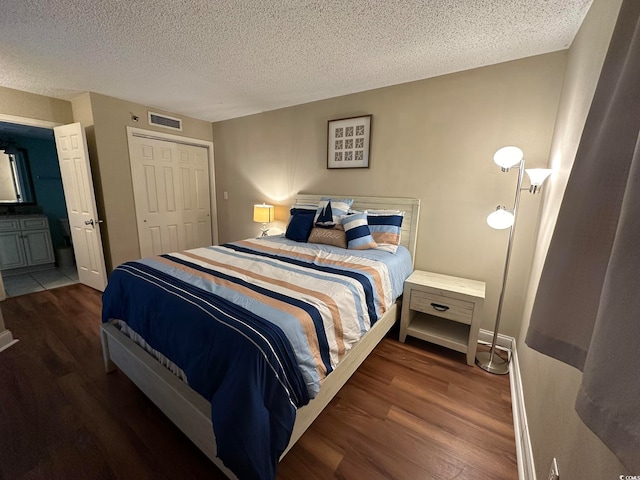 bedroom with tile flooring, a closet, and a textured ceiling