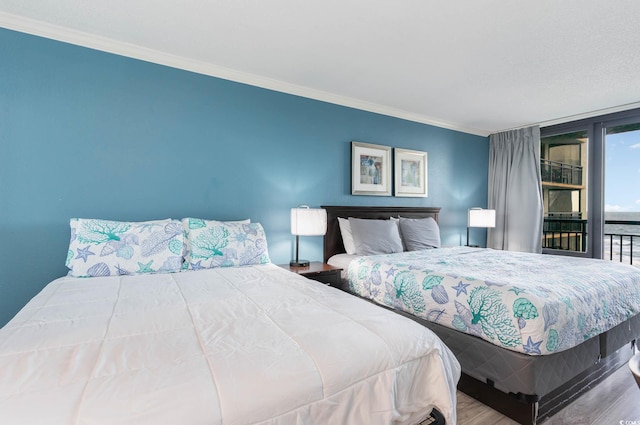 bedroom with crown molding and hardwood / wood-style flooring