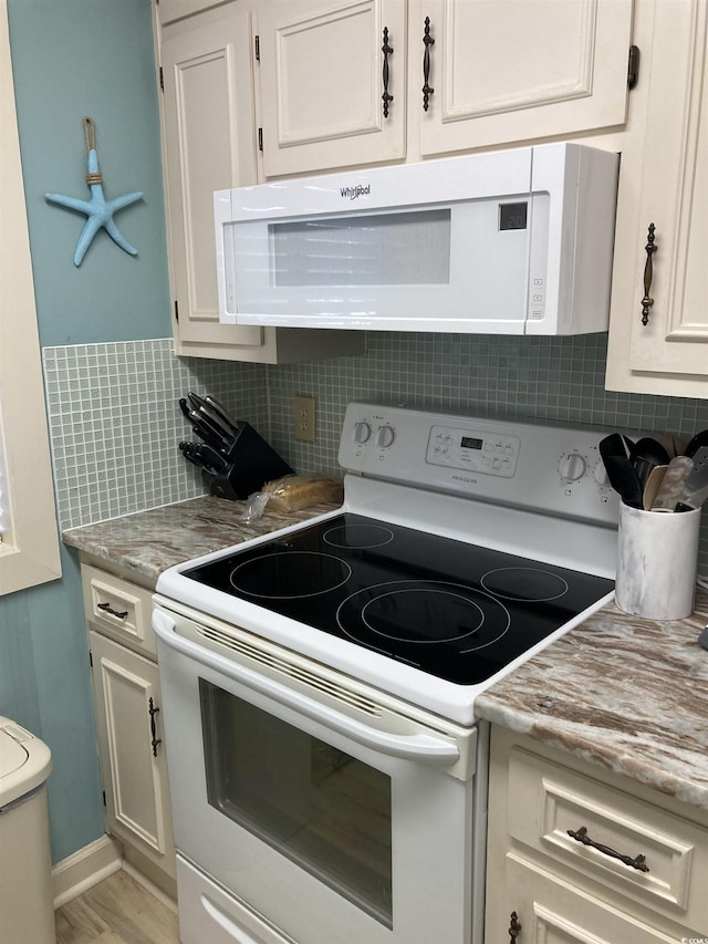 kitchen featuring backsplash, white cabinetry, light hardwood / wood-style floors, and white appliances