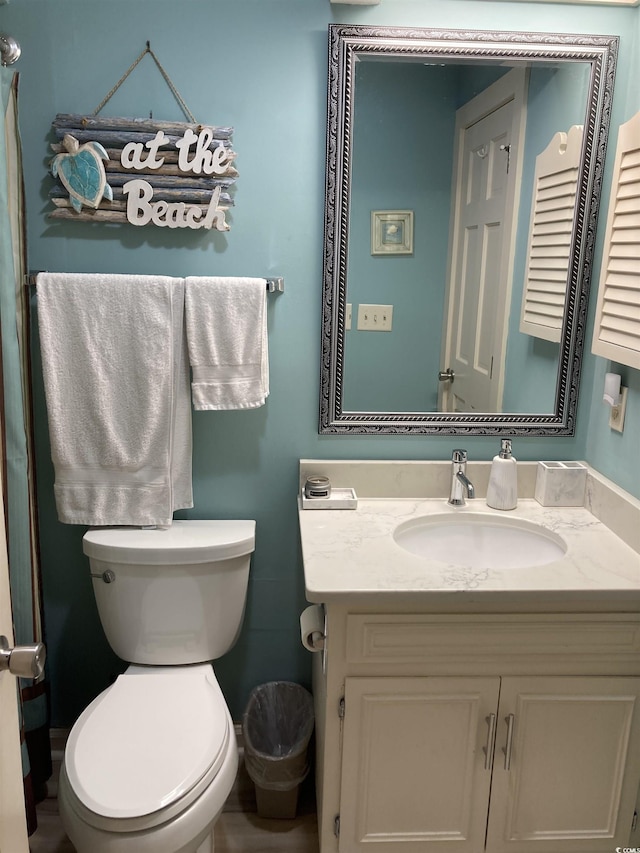 bathroom featuring vanity and toilet