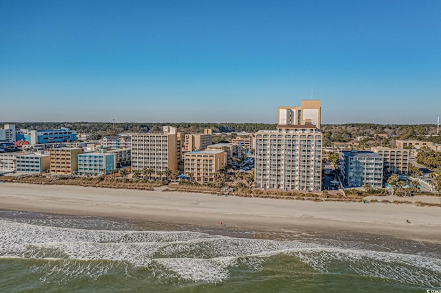 drone / aerial view with a water view and a beach view