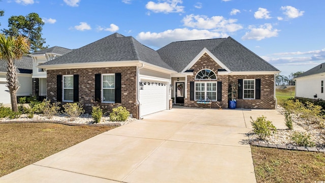 view of front of property with a front lawn and a garage