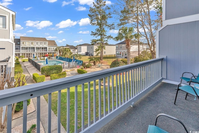 balcony with a fenced in pool