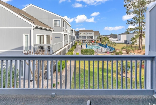 balcony with a fenced in pool