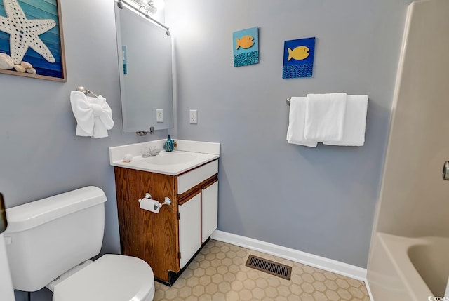 bathroom with toilet, tile floors, and vanity