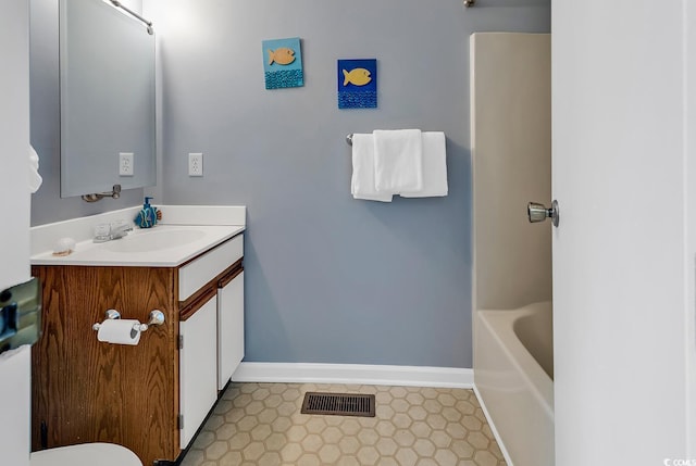 bathroom featuring toilet, tile floors, and vanity with extensive cabinet space