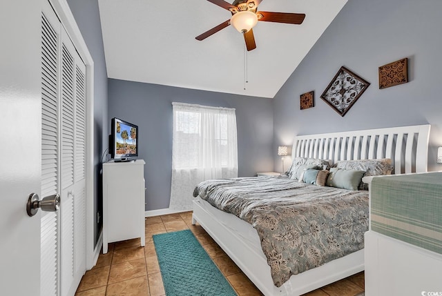 bedroom with lofted ceiling, ceiling fan, and light tile flooring