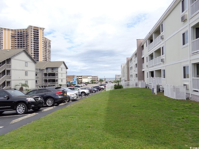 view of parking / parking lot with a lawn