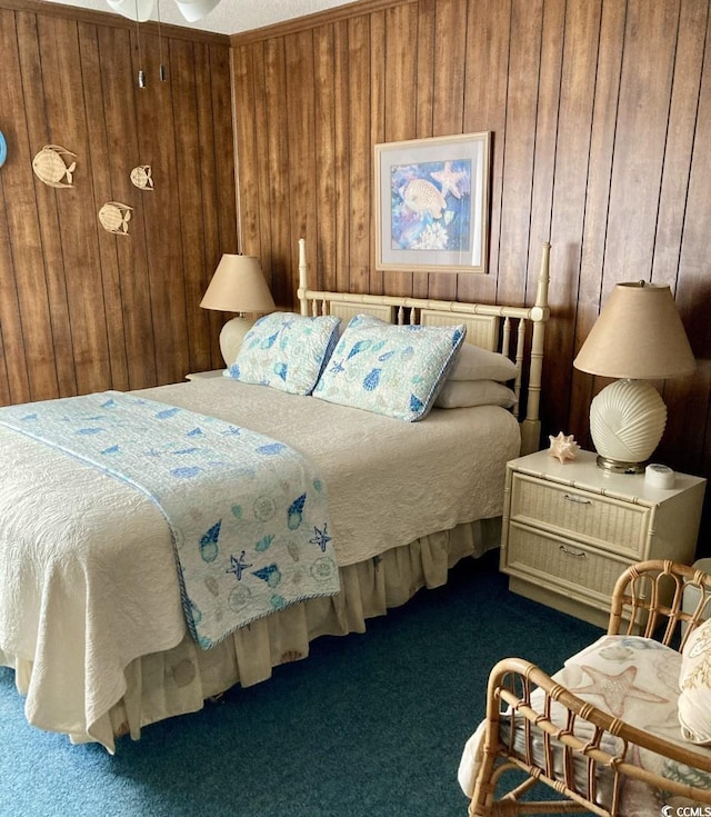 bedroom with wooden walls and dark carpet