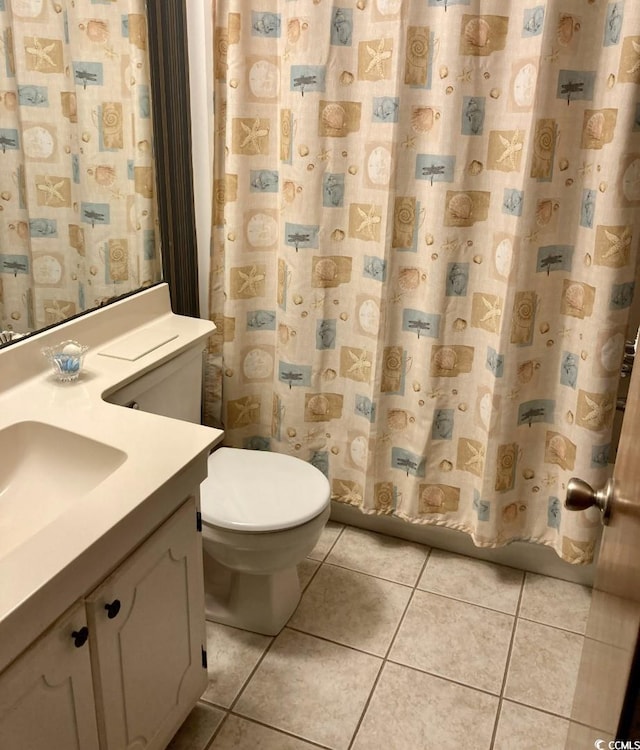 bathroom featuring tile floors, toilet, and vanity