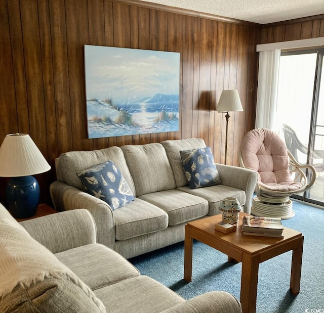 living room featuring carpet floors, a textured ceiling, and wood walls