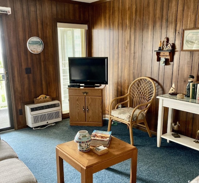 carpeted living room with wood walls and a healthy amount of sunlight