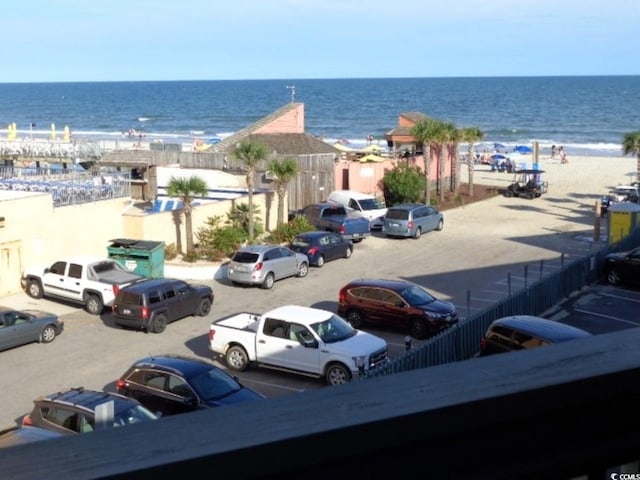 view of vehicle parking with a water view