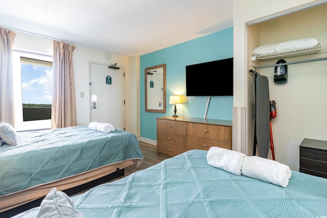 bedroom featuring access to exterior and hardwood / wood-style flooring