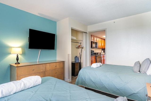 bedroom with wood-type flooring and a closet