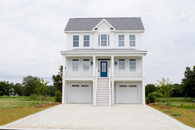 view of front of house featuring a balcony, a front lawn, and a garage