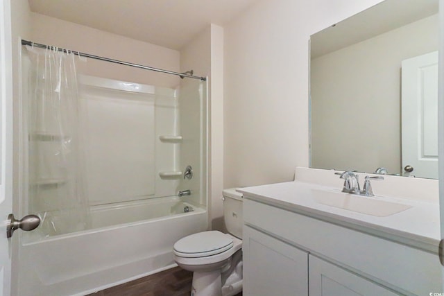 full bathroom featuring vanity with extensive cabinet space, toilet, shower / tub combo, and hardwood / wood-style floors