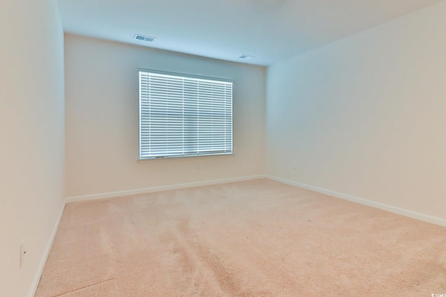 spare room with light colored carpet