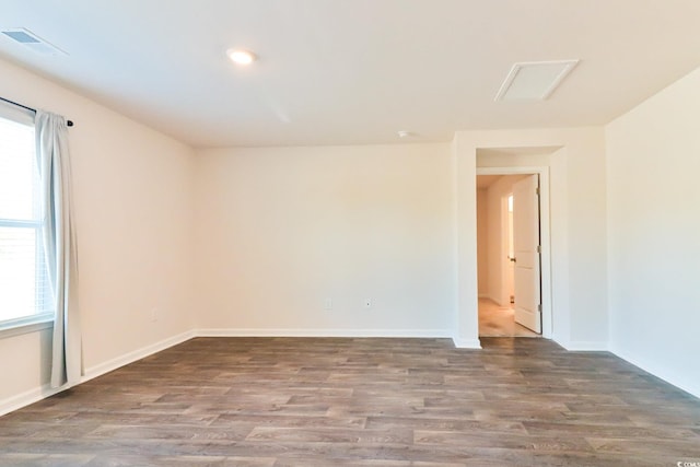 unfurnished room with dark hardwood / wood-style floors