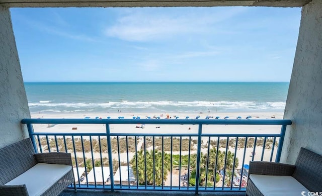 balcony featuring a view of the beach and a water view