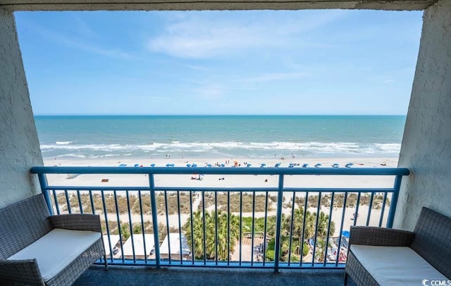 balcony with a beach view and a water view