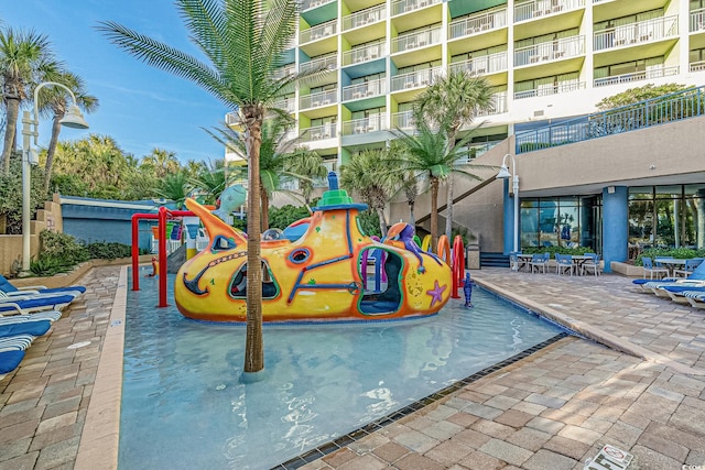 view of pool with a playground