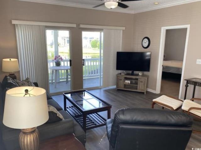 living room with ornamental molding, dark hardwood / wood-style floors, and ceiling fan