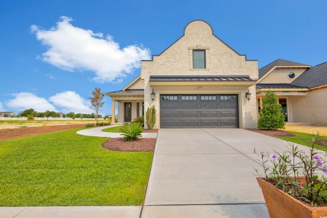 view of front of property featuring a garage and a front lawn