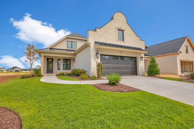 view of front of house with a garage and a front lawn