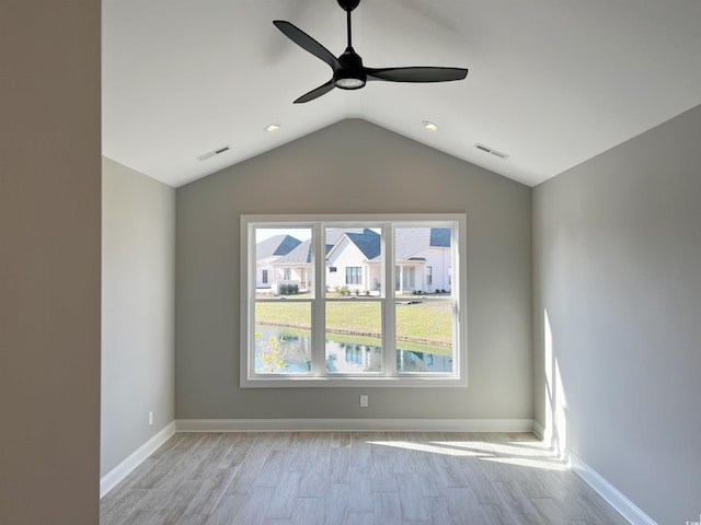 unfurnished room featuring vaulted ceiling, ceiling fan, and light wood-type flooring