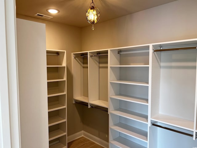 spacious closet featuring hardwood / wood-style floors