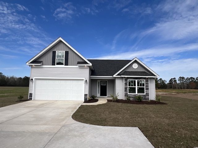 1424 Nathan Dr, Loris, SC 29569 - traditional-style house featuring concrete driveway, a front yard, board and batten siding, and stone siding