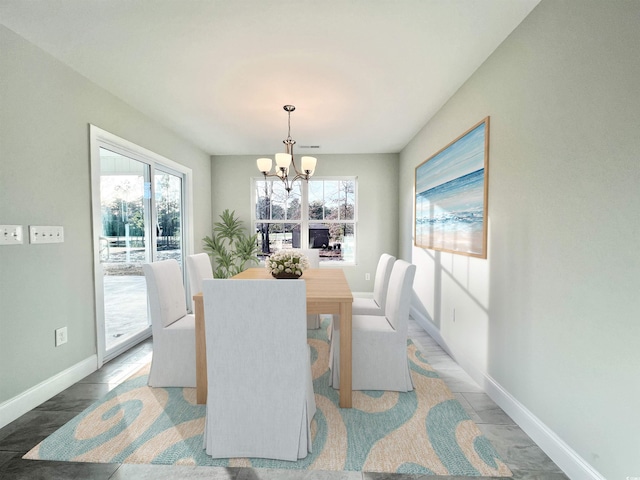 1424 Nathan Dr, Loris, SC 29569 - dining area with baseboards, a wealth of natural light, and a notable chandelier