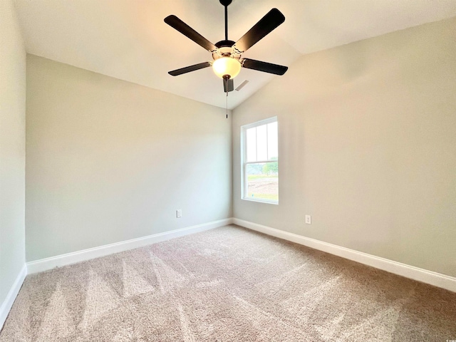 carpeted empty room featuring ceiling fan and vaulted ceiling