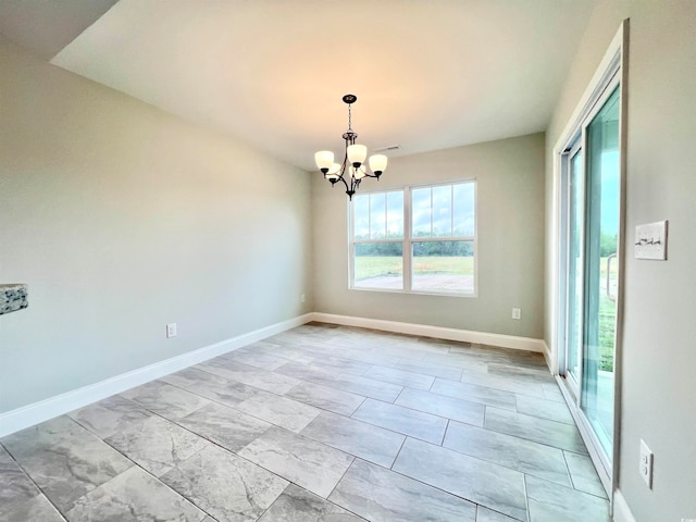 unfurnished room with a notable chandelier