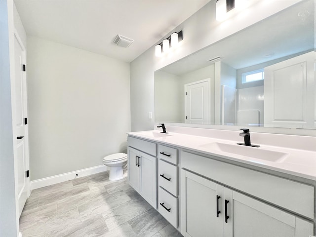1424 Nathan Dr, Loris, SC 29569 - bathroom featuring visible vents, a sink, baseboards, and toilet