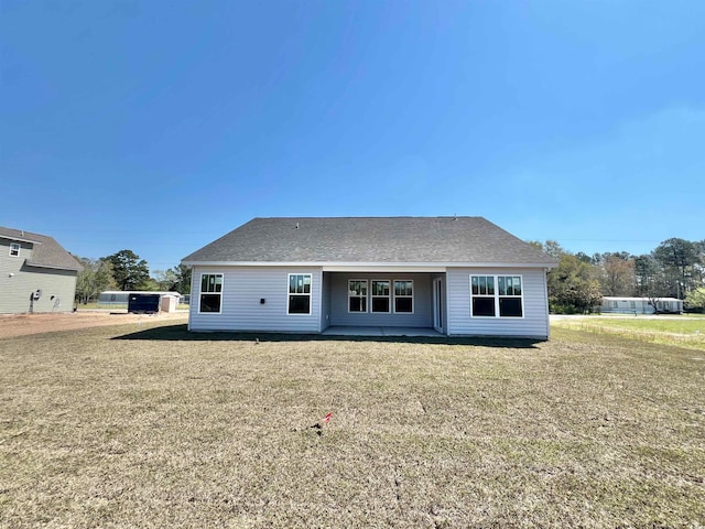 back of property featuring a lawn