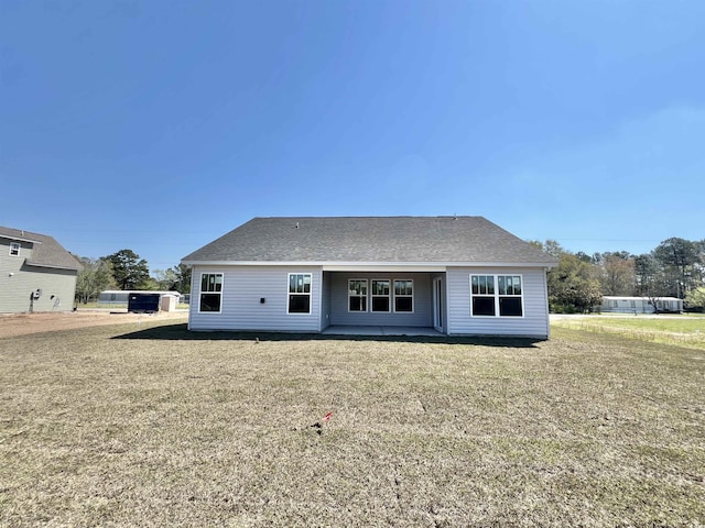 1424 Nathan Dr, Loris, SC 29569 - rear view of house with a yard, a patio, and roof with shingles