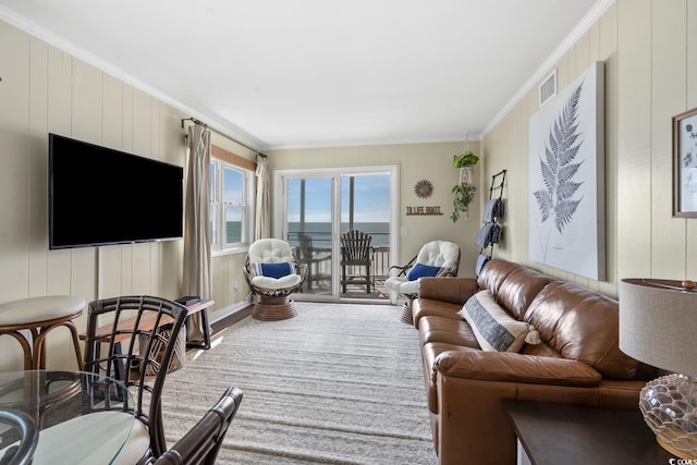 carpeted living room with ornamental molding